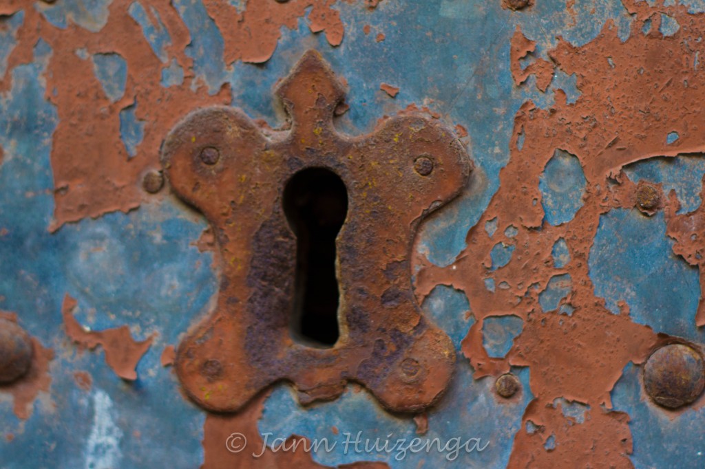 Rusty Keyhole on a tin-clad door, copyright Jann Huizenga